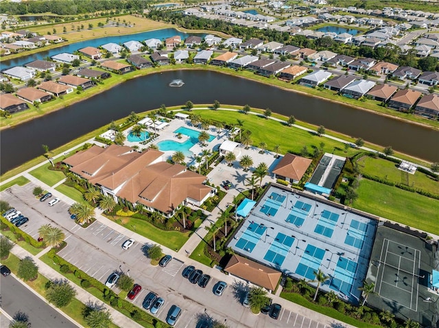 birds eye view of property with a residential view and a water view