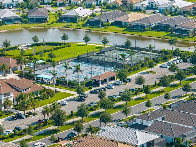 drone / aerial view featuring a water view and a residential view