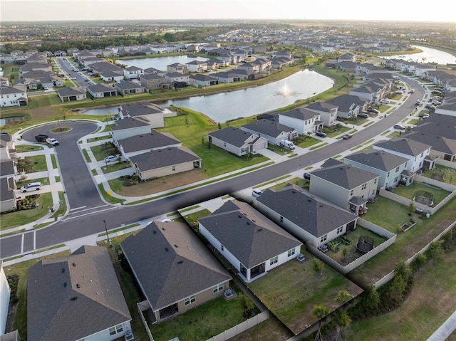 drone / aerial view with a residential view and a water view