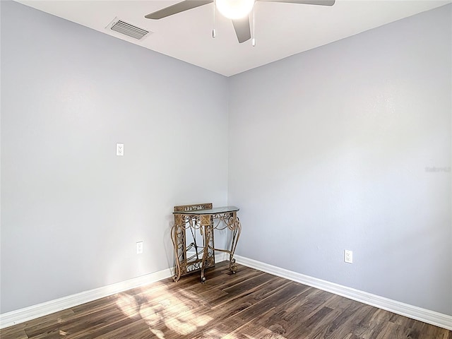 unfurnished room featuring baseboards, ceiling fan, dark wood-style floors, and visible vents