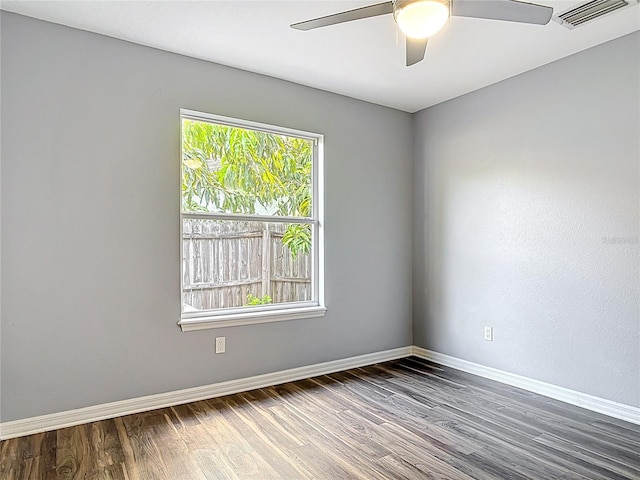 unfurnished room with baseboards, ceiling fan, visible vents, and wood finished floors