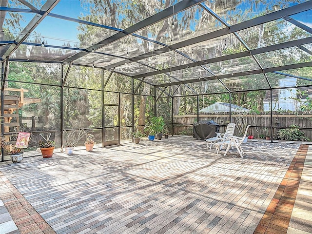 view of patio featuring a lanai and fence private yard