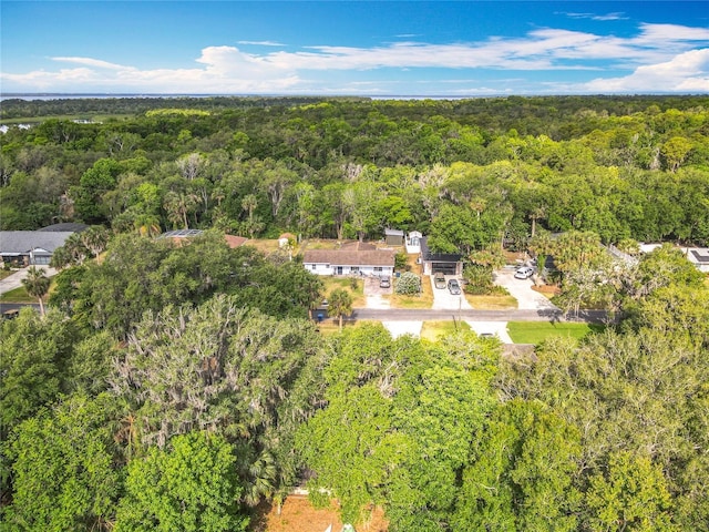 birds eye view of property featuring a view of trees