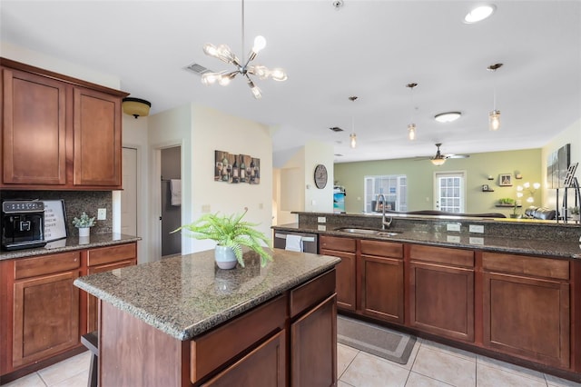 171 Mcleods Way, Winter Springs, FL 32708 - kitchen with a sink, dishwasher, light tile patterned flooring, pendant lighting, and dark stone counters