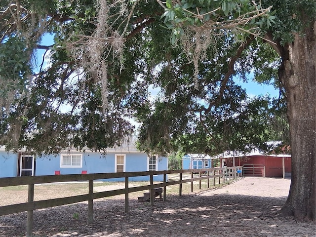 exterior space with fence and an outbuilding