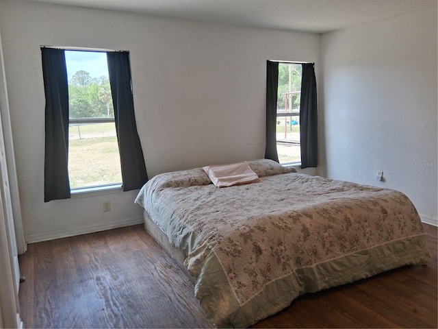 bedroom featuring baseboards and wood finished floors