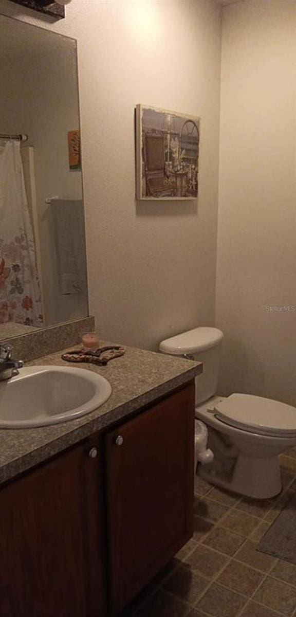 bathroom featuring vanity and toilet
