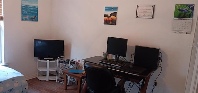 office space with baseboards and wood finished floors