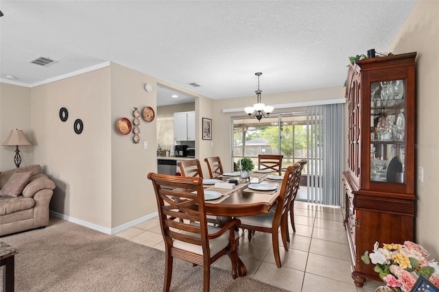 dining space with visible vents, light tile patterned floors, baseboards, a notable chandelier, and light carpet