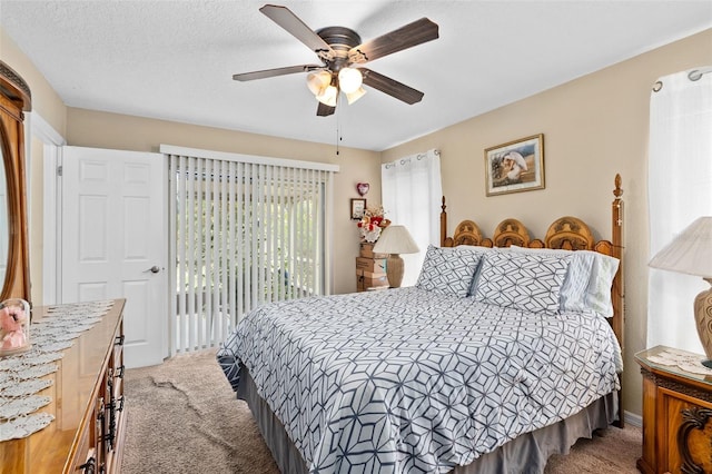 bedroom with carpet floors, access to outside, and a ceiling fan