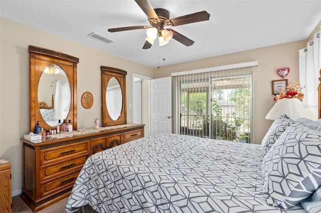 bedroom featuring ceiling fan, visible vents, and access to exterior
