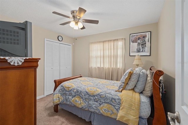 bedroom with a ceiling fan, baseboards, carpet, and a closet