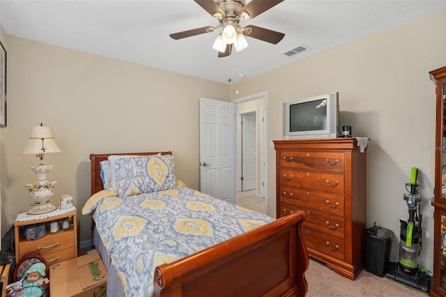bedroom with visible vents, ceiling fan, and light colored carpet