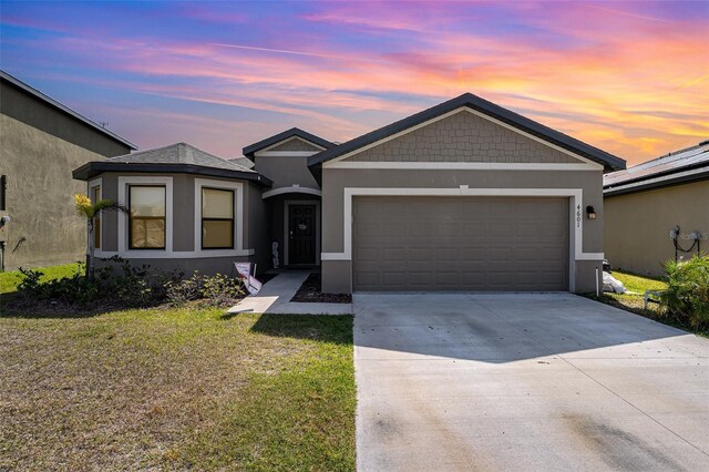 4601 Talbot Blvd, Cocoa, FL 32926 - ranch-style home featuring a garage, stucco siding, driveway, and a front lawn