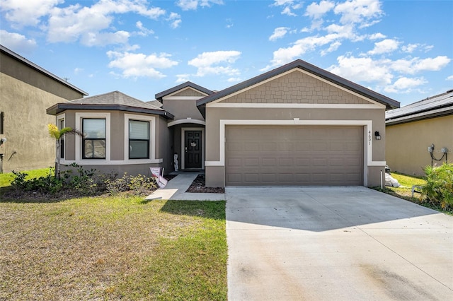 4601 Talbot Blvd, Cocoa, FL 32926 - view of front of home featuring an attached garage, a front lawn, stucco siding, and driveway
