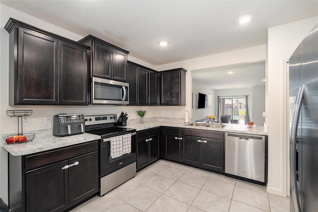 4601 Talbot Blvd, Cocoa, FL 32926 - kitchen featuring stainless steel appliances, a sink, light tile patterned floors, and recessed lighting