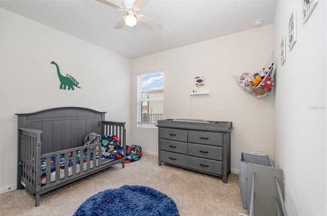 4601 Talbot Blvd, Cocoa, FL 32926 - carpeted bedroom with a nursery area, a ceiling fan, and baseboards