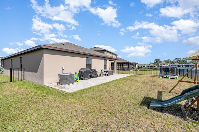 4601 Talbot Blvd, Cocoa, FL 32926 - rear view of property featuring a patio, central AC unit, a fenced backyard, and a playground