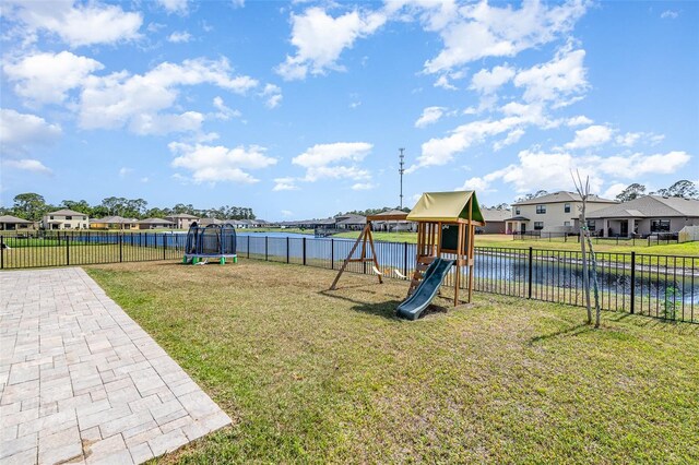 4601 Talbot Blvd, Cocoa, FL 32926 - view of play area featuring a trampoline, a residential view, a fenced backyard, a yard, and a water view
