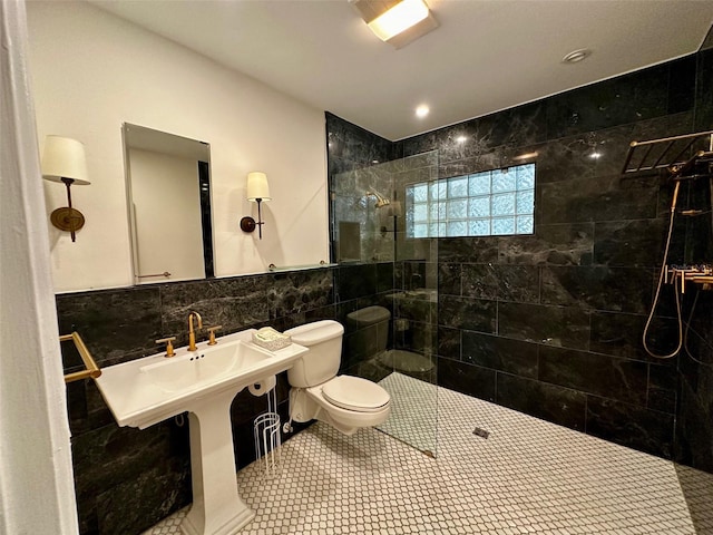 bathroom with tile walls, tile patterned flooring, walk in shower, and toilet