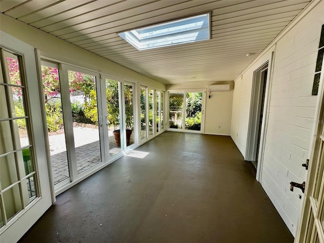 unfurnished sunroom featuring french doors, a wall mounted air conditioner, concrete floors, and a skylight