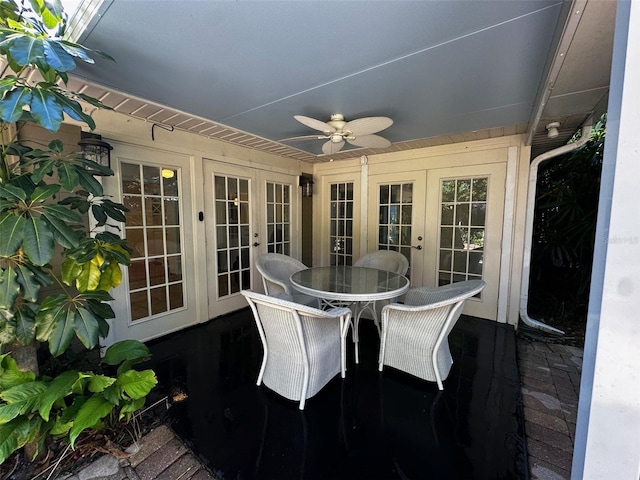 sunroom / solarium with french doors, a ceiling fan, and outdoor dining space