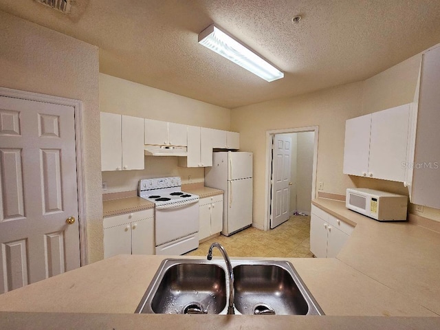 3577 Conroy Rd Unit 331, Orlando, FL 32839 - kitchen featuring a textured ceiling, a sink, under cabinet range hood, white appliances, and white cabinetry