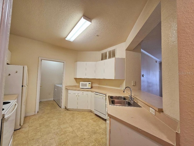 3577 Conroy Rd Unit 331, Orlando, FL 32839 - kitchen with a textured ceiling, independent washer and dryer, a sink, white appliances, and white cabinetry