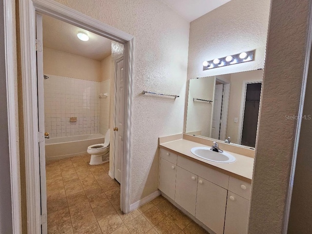 3577 Conroy Rd Unit 331, Orlando, FL 32839 - full bathroom featuring vanity, a textured wall, tile patterned floors, and toilet
