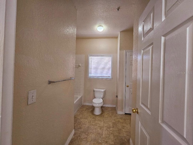3577 Conroy Rd Unit 331, Orlando, FL 32839 - full bathroom with shower / bath combination, a textured ceiling, baseboards, toilet, and a textured wall