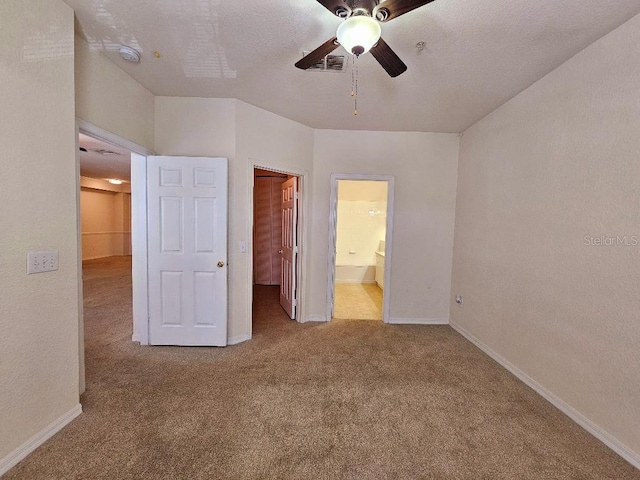 3577 Conroy Rd Unit 331, Orlando, FL 32839 - unfurnished bedroom featuring a walk in closet, baseboards, carpet, and connected bathroom