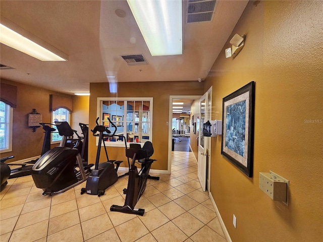 3577 Conroy Rd Unit 331, Orlando, FL 32839 - workout area featuring baseboards, visible vents, and light tile patterned floors