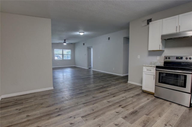 kitchen with visible vents, white cabinets, open floor plan, stainless steel electric stove, and under cabinet range hood