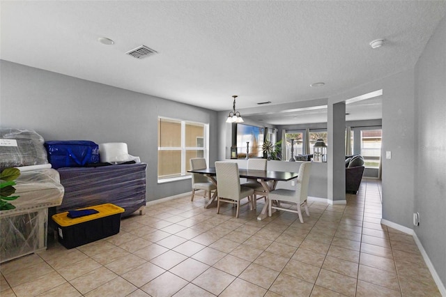 2806 Polson Dr, Kissimmee, FL 34758 - dining room with light tile patterned flooring, baseboards, a chandelier, and a textured ceiling