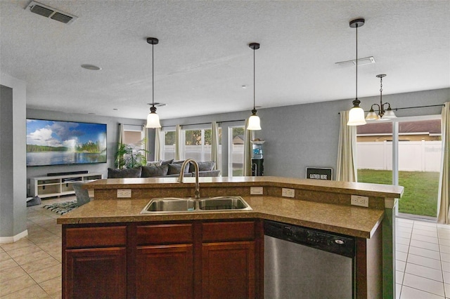 2806 Polson Dr, Kissimmee, FL 34758 - kitchen with dishwasher, a sink, open floor plan, light tile patterned floors, and a textured ceiling
