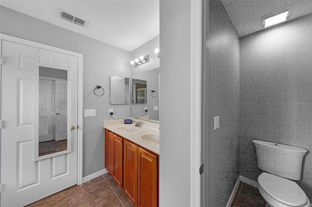2806 Polson Dr, Kissimmee, FL 34758 - bathroom with double vanity, tile patterned floors, toilet, and baseboards