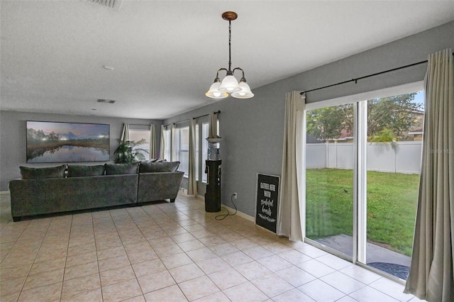 2806 Polson Dr, Kissimmee, FL 34758 - living room with a chandelier and light tile patterned floors
