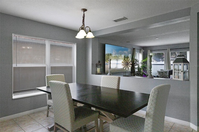 2806 Polson Dr, Kissimmee, FL 34758 - dining area with light tile patterned flooring, a chandelier, and baseboards