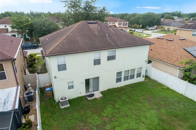 2806 Polson Dr, Kissimmee, FL 34758 - rear view of house with stucco siding, central AC, roof with shingles, and a residential view