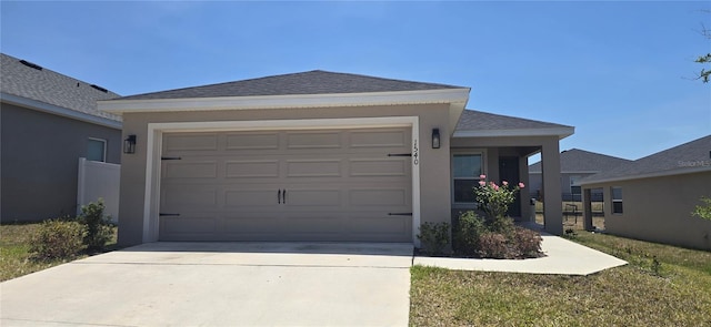 single story home featuring roof with shingles, an attached garage, driveway, and stucco siding