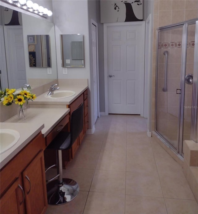 full bath with vanity, tile patterned floors, and a stall shower