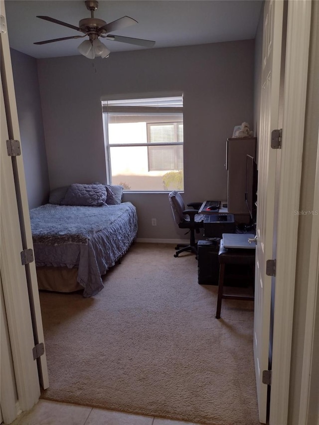 carpeted bedroom with a ceiling fan and baseboards