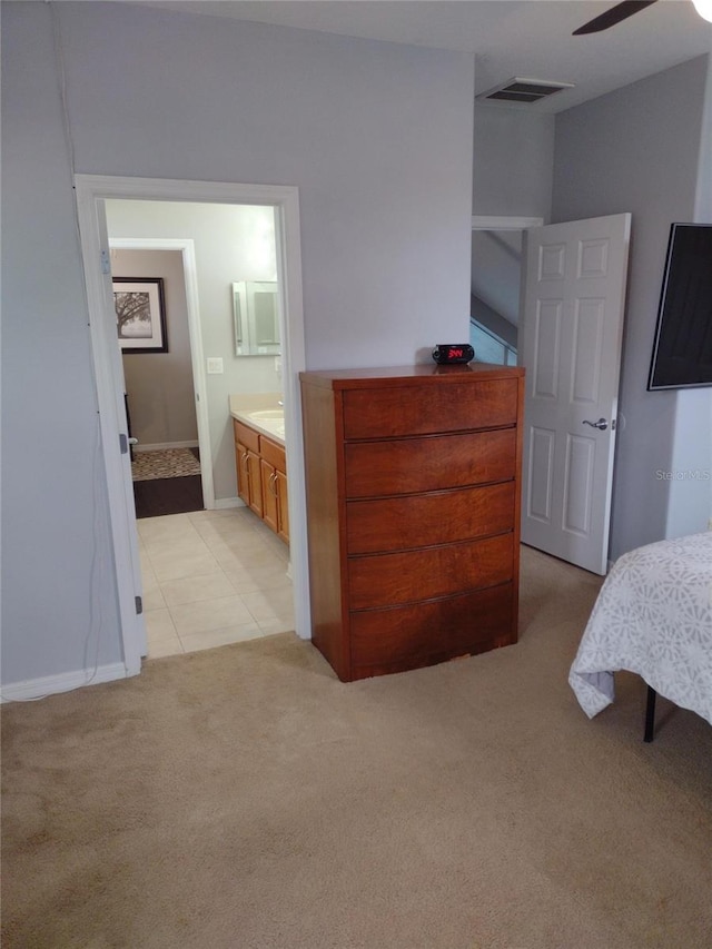 bedroom featuring visible vents, light carpet, baseboards, ceiling fan, and connected bathroom