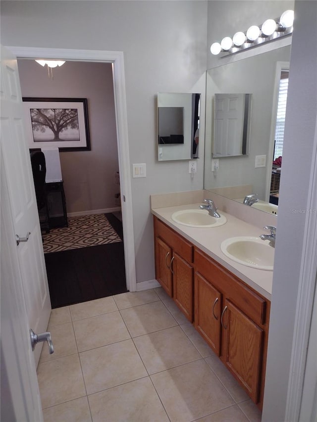 full bath featuring a sink, tile patterned flooring, and double vanity