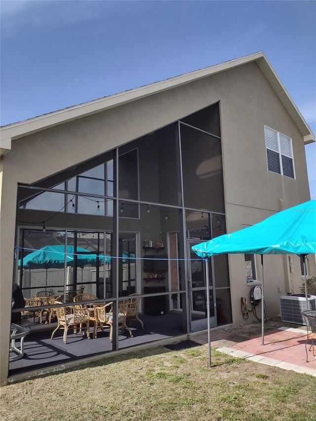 back of house with a patio, stucco siding, fence, and cooling unit
