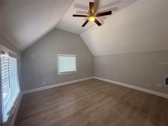 bonus room featuring ceiling fan, dark wood finished floors, baseboards, lofted ceiling, and visible vents