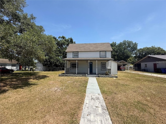 bungalow-style home with covered porch and a front lawn