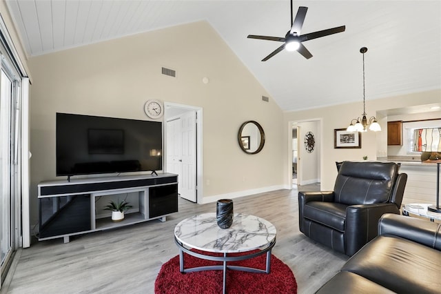 1136 Villa Ln Unit 96, Apopka, FL 32712 - living area featuring visible vents, baseboards, high vaulted ceiling, light wood finished floors, and ceiling fan with notable chandelier