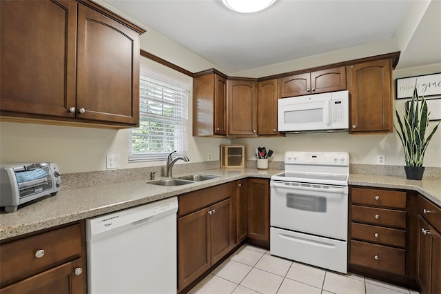 1136 Villa Ln Unit 96, Apopka, FL 32712 - kitchen featuring a sink, light tile patterned floors, a toaster, light stone counters, and white appliances