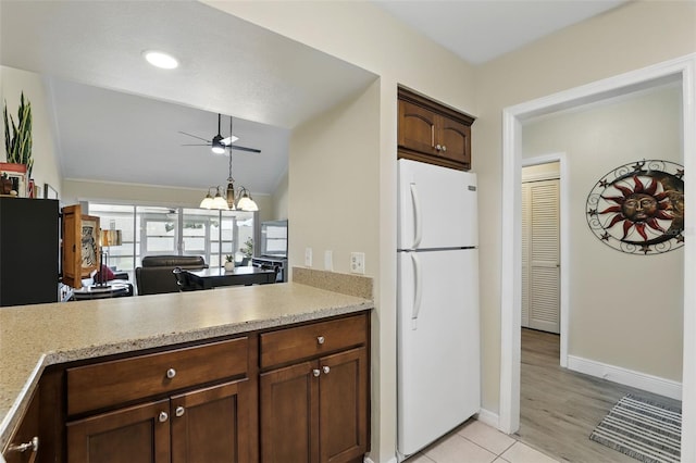 1136 Villa Ln Unit 96, Apopka, FL 32712 - kitchen with freestanding refrigerator, ceiling fan, vaulted ceiling, and light countertops